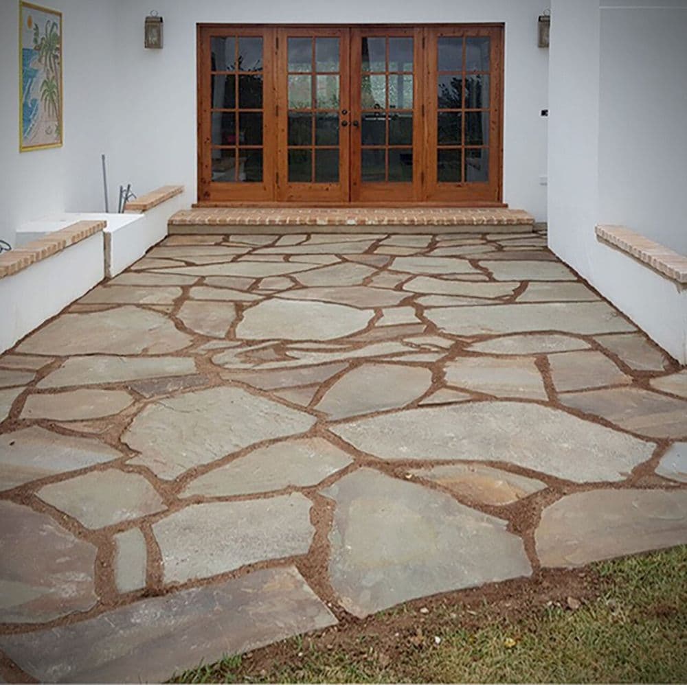 A natural flagstone patio leading to French doors